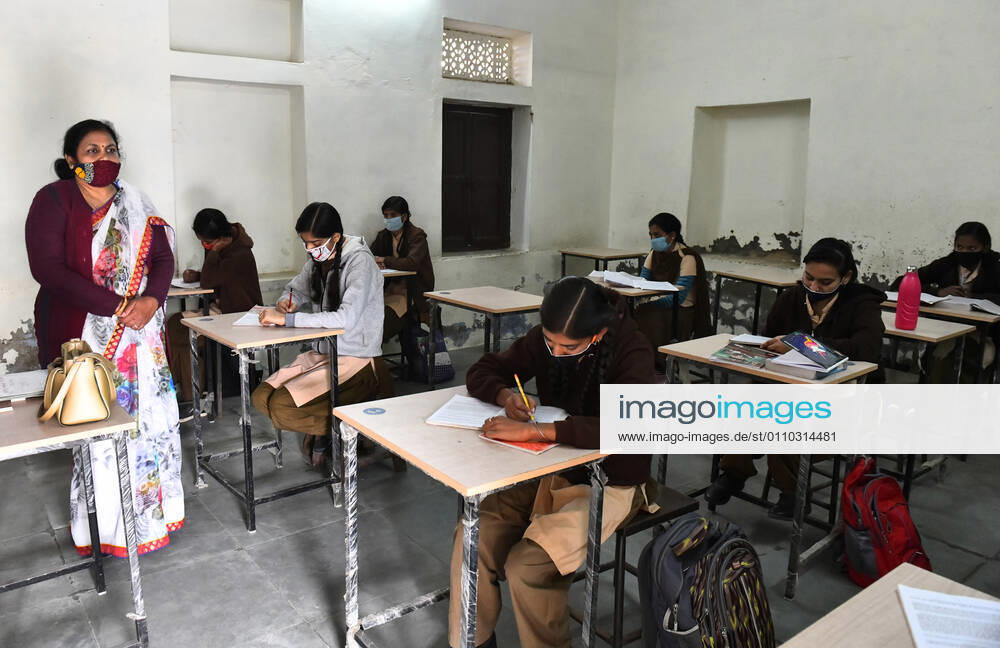 India: Schools reopened after 10 months in Rajasthan A teacher wearing face mask takes the class of students at a government school that was reopened after remaining closed for 309 days due to COVID-19 pandemic in Beawar. Beawar Rajasthan India