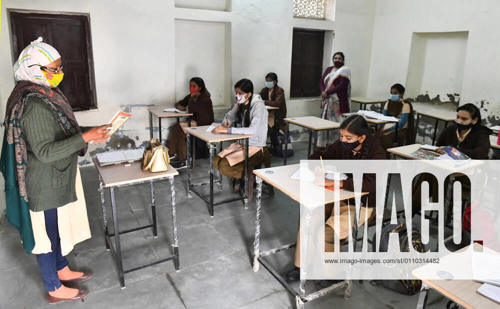 India: Schools reopened after 10 months in Rajasthan A teacher wearing face mask takes the class of students at a government school that was reopened after remaining closed for 309 days due to COVID-19 pandemic in Beawar. Beawar Rajasthan India