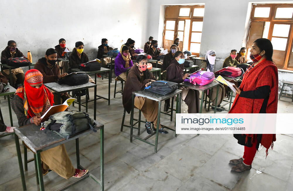 India: Schools reopened after 10 months in Rajasthan A teacher wearing face mask takes the class of students at a government school that was reopened after remaining closed for 309 days due to COVID-19 pandemic in Beawar. Beawar Rajasthan India