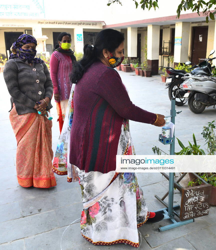 India: Schools reopened after 10 months in Rajasthan Teachers get their hands sanitised as they arrive to attend classes at a government school that was reopened after remaining closed for 309 days due to COVID-19 pandemic in Beawar. Beawar Rajasthan India