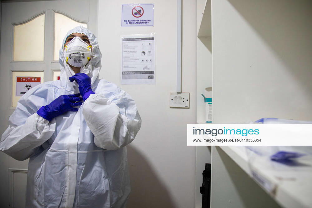 A laboratory technologist Srijana Adhikari adjusts her personal protective equipment (PPE) at the Bidh Lab..Nepal has confirmed that a new variant of coronavirus has entered Nepal as well. Issuing a statement on Monday the Ministry of Health and Population stated that three out of six people who arrived here from the UK a few days ago are found infected with the new variant. Kathmandu Nepal - ZUMAs197 20210118_zaa_s197_109