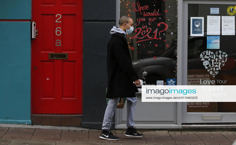 (210120) -- LONDON, Jan. 20, 2021 -- A man wearing a face mask walks past a closed travel agent shop with Where would you go in 2021? seen on the glass window in London, Britain, on Jan. 19, 2021. The number of people who have died within 28 days of a positive coronavirus test has surpassed the grim milestone of 90,000 in Britain after another 1,610 were confirmed, according to official figures released Tuesday. The latest daily death toll, the highest since the pandemic began in the country, brought the total number of coronavirus-related deaths in Britain to 91,470, the data showed. ) BRITAIN-LONDON-COVID-19-DEATH TOLL HanxYan