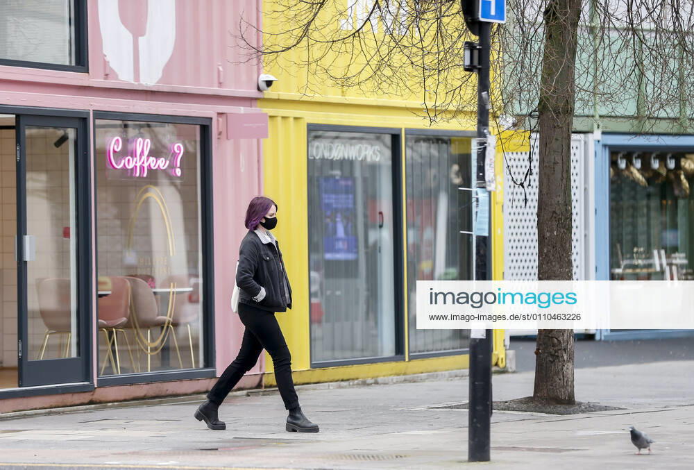 (210120) -- LONDON, Jan. 20, 2021 -- A woman wearing a face mask walks on the street in London, Britain, on Jan. 19, 2021. The number of people who have died within 28 days of a positive coronavirus test has surpassed the grim milestone of 90,000 in Britain after another 1,610 were confirmed, according to official figures released Tuesday. The latest daily death toll, the highest since the pandemic began in the country, brought the total number of coronavirus-related deaths in Britain to 91,470, the data showed. ) BRITAIN-LONDON-COVID-19-DEATH TOLL HanxYan