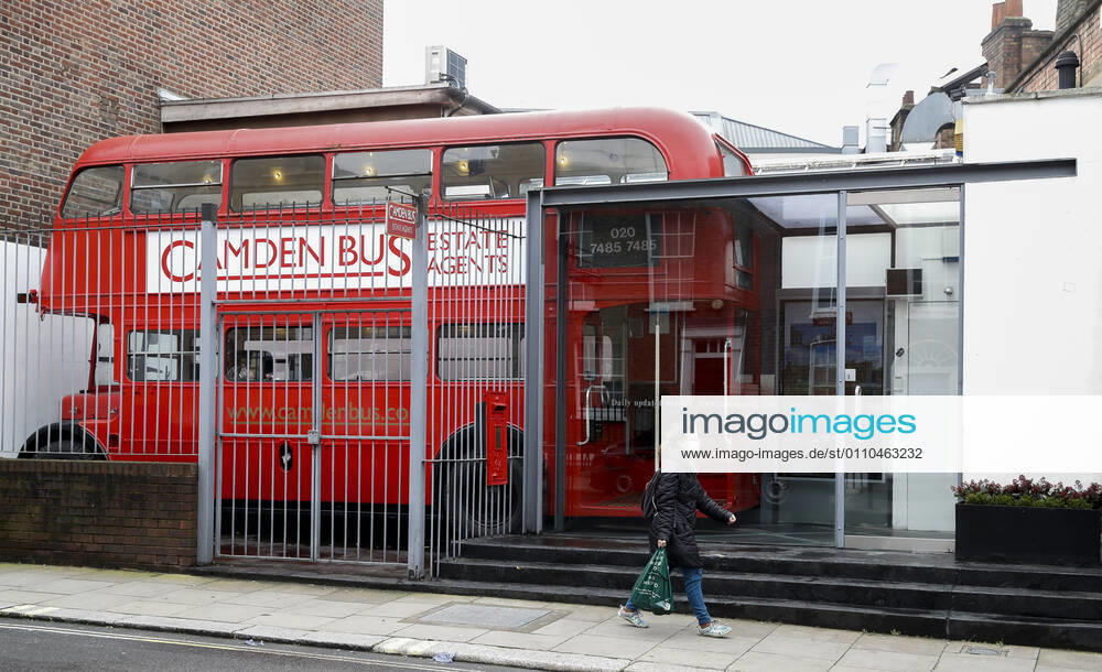 (210120) -- LONDON, Jan. 20, 2021 -- A woman wearing a face mask walks past an Estate Agent in the shape of a red double decker in London, Britain, on Jan. 19, 2021. The number of people who have died within 28 days of a positive coronavirus test has surpassed the grim milestone of 90,000 in Britain after another 1,610 were confirmed, according to official figures released Tuesday. The latest daily death toll, the highest since the pandemic began in the country, brought the total number of coronavirus-related deaths in Britain to 91,470, the data showed. ) BRITAIN-LONDON-COVID-19-DEATH TOLL HanxYan