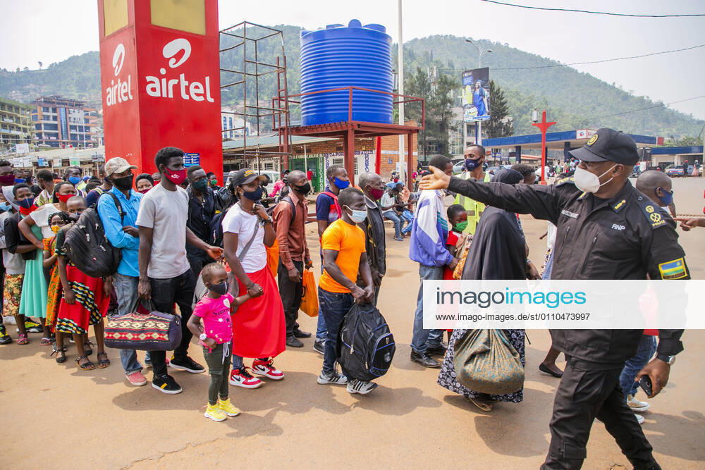 (210120) -- KIGALI, Jan. 20, 2021 -- A police officer guides passengers at a bus station in Kigali, Rwanda, Jan. 19, 2021. Rwandan cabinet on Monday brought the capital city of Kigali back to a lockdown due to a surge in COVID-19 cases. The lockdown, which became effective immediately and will be reviewed after 15 days, prohibits unnecessary movements in the city. (Photo by Xinhua) RWANDA-KIGALI-COVID-19-LOCKDOWN CyrilxNdegeya