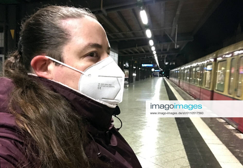 Berlin, GER - Frau auf einem S-Bahnhof traegt in Zeiten der Coronapandemie eine FFP2-Maske. (MR=yes, 40-50 Jahre, Alltag, Atemmaske, aussen, Aussenaufnahme, Bahn, Bahnhof, Berlin, Coronaepidemie, Coronainfektion, Coronakrise, Coronapandemie, Coronavirus, Coronavirus SARS-CoV-2, Covid 19, Covid-19, deutsch, Deutschland, Europa, europaeisch, FFP2, FFP2-Maske, Frau, geschuetzt, Gesellschaft, Jahreszeit, Kaukasierin, kaukasisch, Maske, Maskengebot, Maskenpflicht, Mensch, Mund-Nase-Schutz, Mund-Nasen-Schutz, Mundschutz, Mundschutzgebot, Mundschutzpflicht, Nacht, Nachtaufnahme, nachts, Nahverkehr, oeffentlicher Personennahverkehr, OEPNV, Person, Personennahverkehr, QF, Querformat, S-Bahn, S-Bahnhof, Schutz, Schutzmaske, verpflichtend,