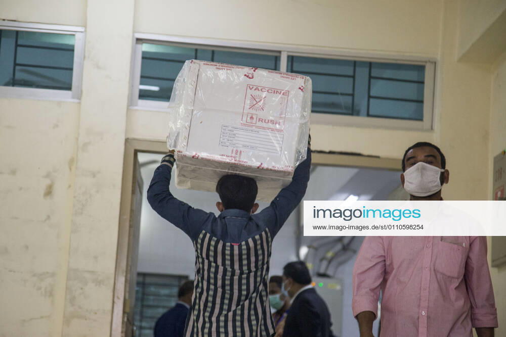 A worker carries a carton of Oxford-AstraZeneca COVID-19 vaccines that arrived from India to Bangladesh as a gift. Dhaka Bangladesh - ZUMAr331 20210121_zip_r331_005