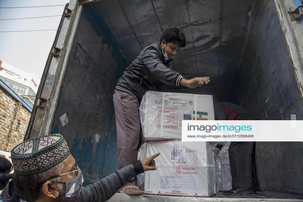 Workers unload a covered van that carries Oxford-AstraZeneca COVID-19 vaccines which arrived from India to Bangladesh as a gift. Dhaka Bangladesh - ZUMAr331 20210121_zip_r331_013
