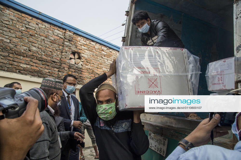 A worker carries a carton of Oxford-AstraZeneca COVID-19 vaccines that arrived from India to Bangladesh as a gift. Dhaka Bangladesh - ZUMAr331 20210121_zip_r331_015