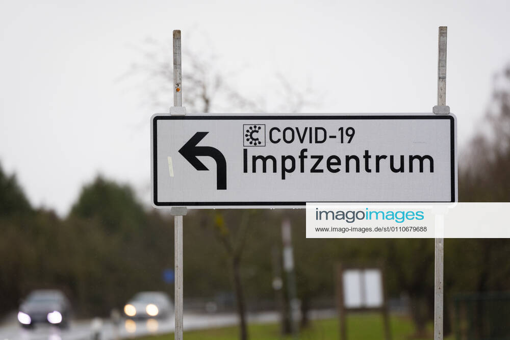 current events, Corona vaccinations in Hesse, Corona vaccination center Giessen, Roller furniture store Heuchelheim symbol photo street sign, signpost to Covid 19 vaccination center Giessen Heuchelheim Corona vaccination center Hesse Germany