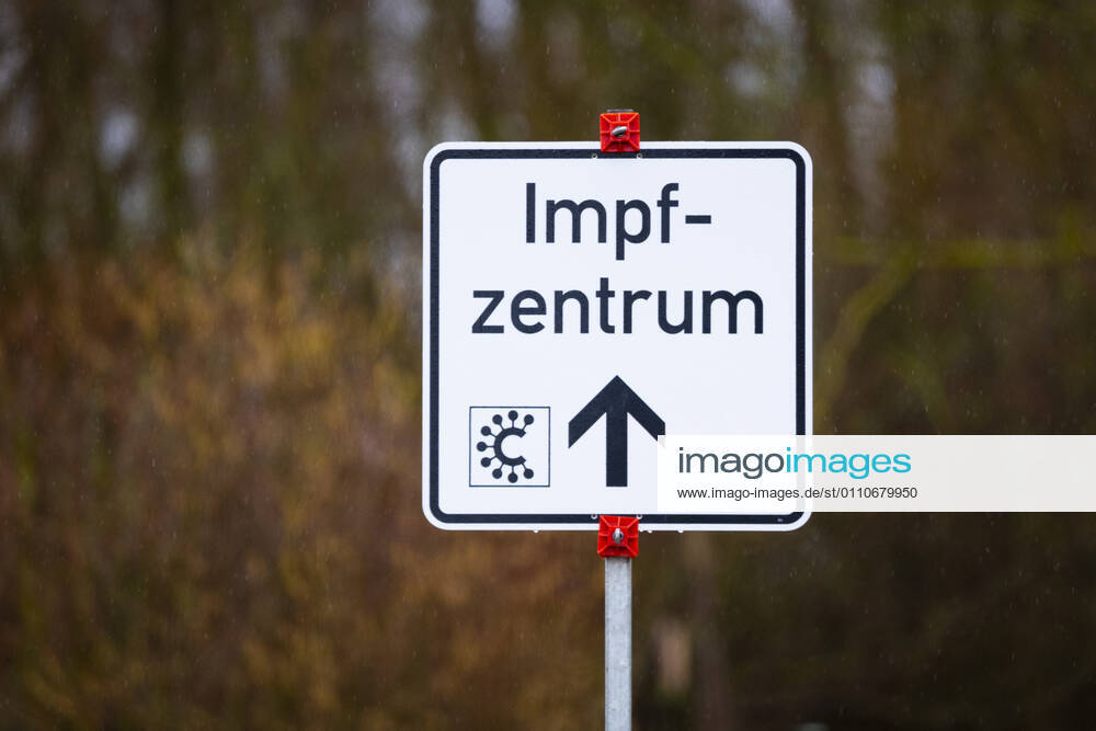 current events, Corona vaccinations in Hesse, Corona vaccination center Giessen, Roller furniture store Heuchelheim symbol photo street sign, signpost to Covid 19 vaccination center Heuchelheim Corona vaccination center Hesse Germany