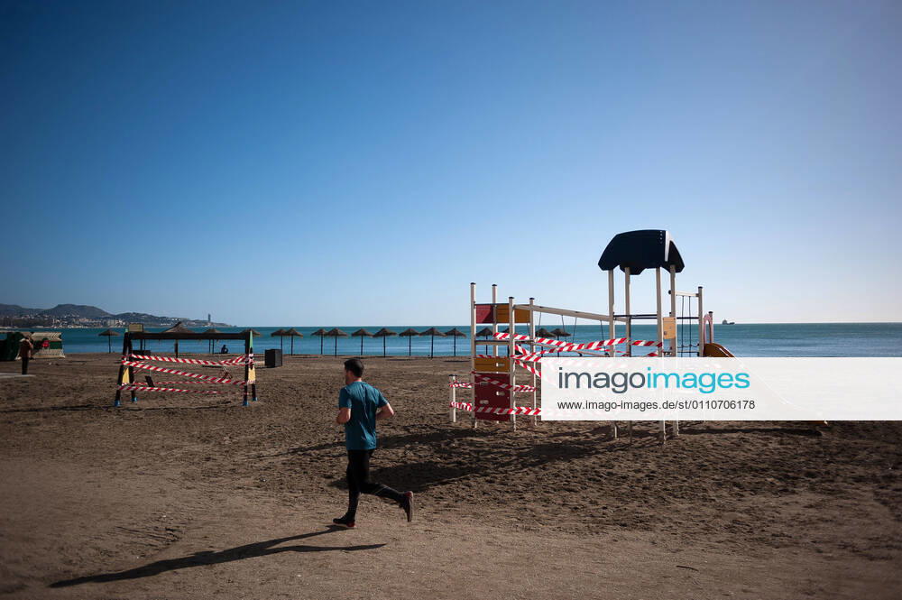 A man jogging around a closed park at La Malagueta beach amid coronavirus pandemic..The region of Andausia suffers an uncontrolled daily rise of coronavirus cases, despite of hard restrictions imposed in the daily life. During the last weeks, Andalusia has reported thousands of infections everyday in the region while the hospital pressure continue rising. Malaga Spain - ZUMAs197 20210122_zaa_s197_029