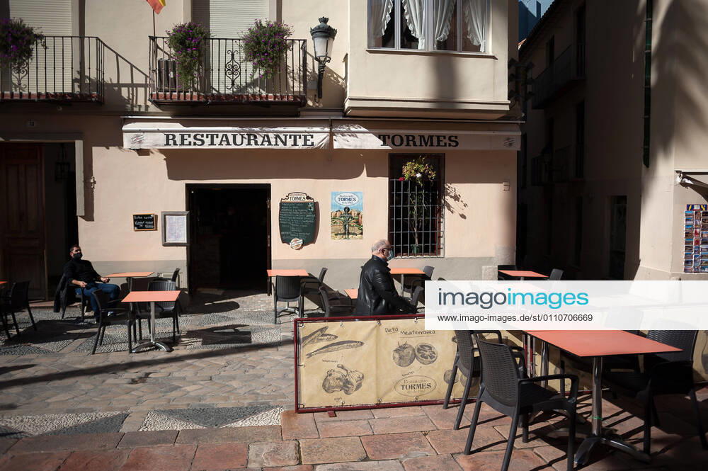 A costumer seen sitting at an empty terrace outside Tormes restaurant in downtown city amid coronavirus pandemic..The region of Andausia suffers an uncontrolled daily rise of coronavirus cases, despite of hard restrictions imposed in the daily life. During the last weeks, Andalusia has reported thousands of infections everyday in the region while the hospital pressure continue rising. Malaga Spain - ZUMAs197 20210122_zaa_s197_046