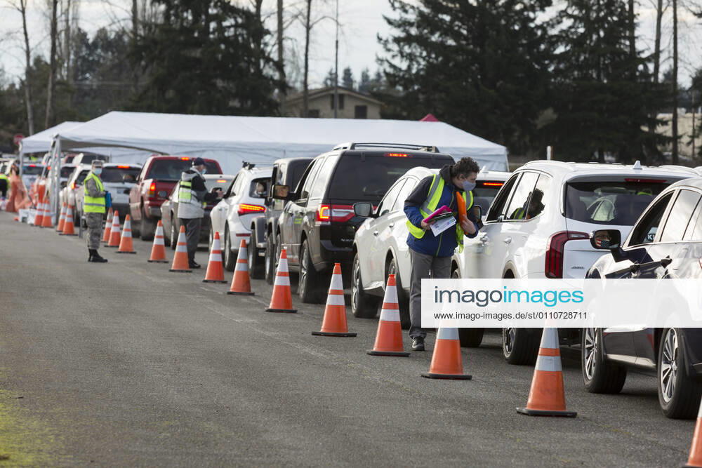 Workers screen patients as they arrive at a COVID-19 vaccination site at the Evergreen State Fairgrounds in Monroe, Washington on Friday, January 22, 2021. The site reopened today after closing on Thursday due to a shortage of vaccine stock. This week, Washington State moved to Phase 1B tier 1 making vaccines available to anyone 65 and older and all peopleÃ‚ 50 and older who also live in a multigenerational household. Monroe USA - ZUMAg235 20210122_zap_g235_003