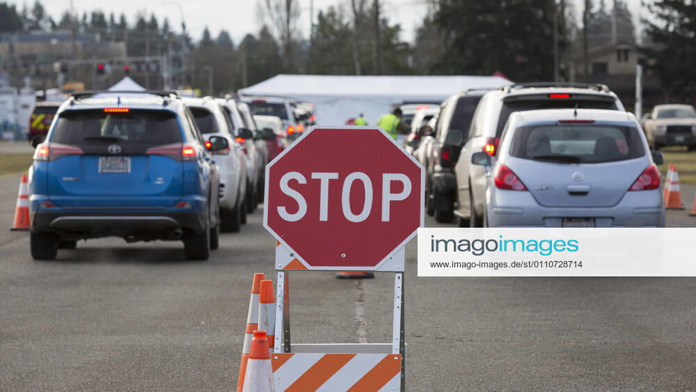 Cars cue up at a COVID-19 vaccination site at the Evergreen State Fairgrounds in Monroe, Washington on Friday, January 22, 2021. The site reopened today after closing on Thursday due to a shortage of vaccine stock. This week, Washington State moved to Phase 1B tier 1 making vaccines available to anyone 65 and older and all people 50 and older who also live in a multigenerational household. Monroe USA - ZUMAg235 20210122_zap_g235_006