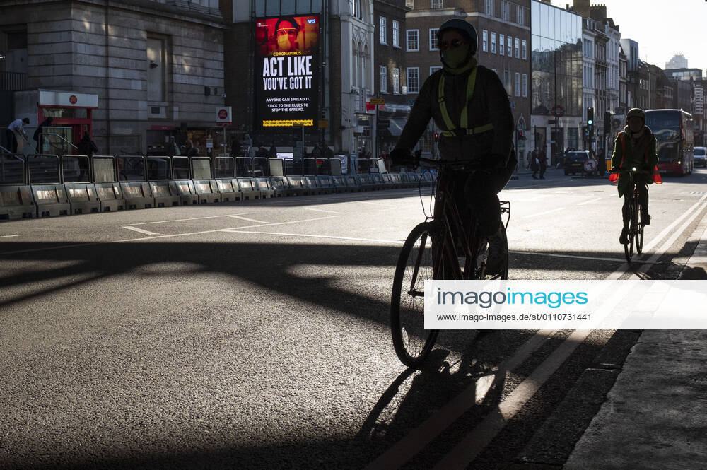 A man wearing a face mask riding bicycle in the city of London, UK on January 22, 2021. Early evidence suggests the variant of coronavirus that emerged in the UK may be more deadly, Prime Minister Boris Johnson said. London United Kingdom - ZUMAj323 20210122_zip_j323_004