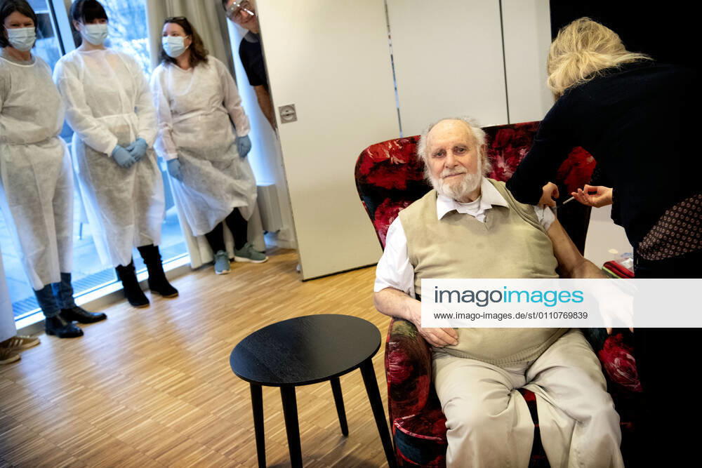 Resident Carl Einar Joergensen receives second vaccine from Pfizer BioNTech by doctor Puk Laugen at Plejecenter Faelledgaarden in OEsterbro in Copenhagen, Saturday 23 January 2021, Copenhagen