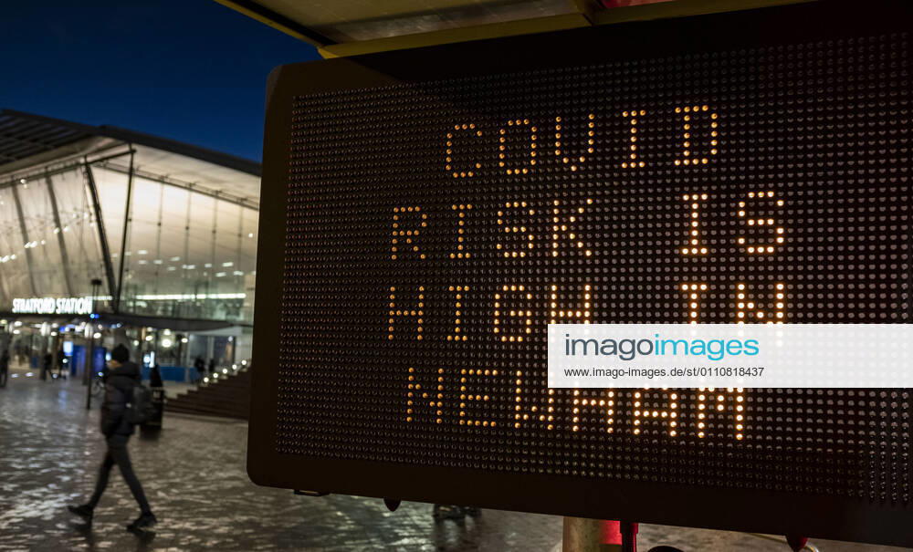 A person passing the COVID sign read â€oeCovid risk is high in Newham†in Stratford, the London Borough of Newham, England, UK on January 23, 2021. Some of England s Covid hotspots are still in London Hounslow, Ealing, Brent, Barking and Dagenham and Newham are the boroughs which fall in the country s top 10 for worst case rates. London United Kingdom - ZUMAj323 20210123_zip_j323_015