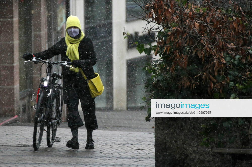 Winter wetter mit Schnee , a women with Safety mask FFP2 is seen under the snow during the Hard Lockdown of the Covid 19 Coronavirus Pandemie in Nuremberg Nurnberg , Bayern , Deutschland . January 24 , 2021.