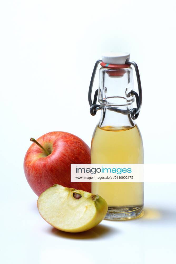 Bottle with apple cider vinegar and apples
