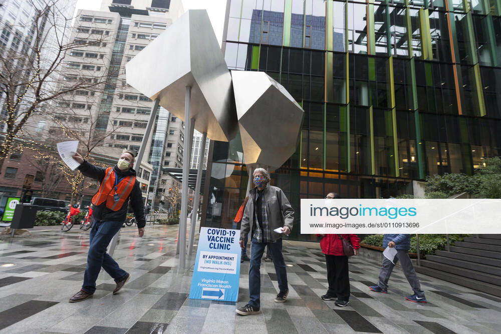 Seattle, Washington, U.S: Workers guide patients to the end of the line as they arrive at a pop up COVID-19 vaccine clinic at the Amazon Headquarters in Seattle on Sunday, January 24, 2021. Amazon partnered with Virginia Mason Franciscan Health to vaccinate 2,000 Washingtonians who currently qualify to be vaccinated under the stateÃ¢â‚¬â ¢s COVID-19 Vaccine Phases guidelines. Seattle U.S. - ZUMAg235 20210124_zap_g235_002
