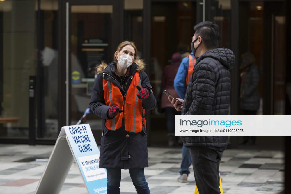 A worker directs patients as they arrive at a pop up COVID-19 vaccine clinic at the Amazon Headquarters in Seattle on Sunday, January 24, 2021. Amazon partnered with Virginia Mason Franciscan Health to vaccinate 2,000 Washingtonians who currently qualify to be vaccinated under the stateâ€⠢s COVID-19 Vaccine Phases guidelines. Seattle USA - ZUMAg235 20210124_zap_g235_020