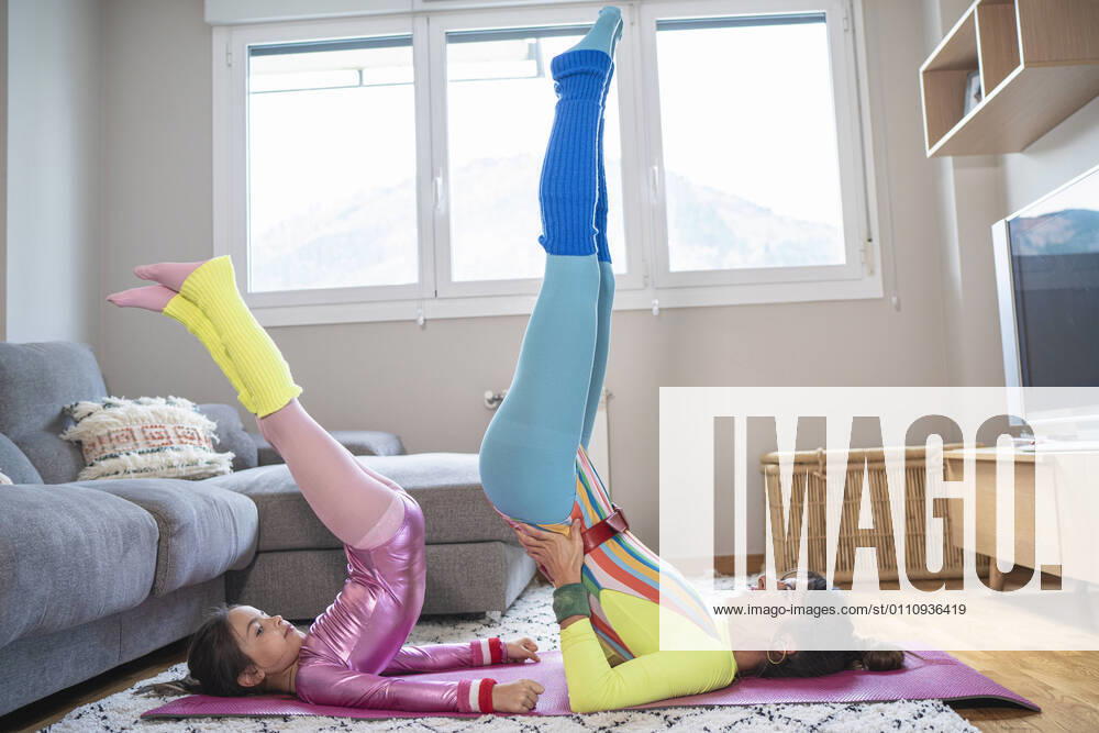 Mother and daughter doing stretching exercise at home model released Symbolfoto property released SNF00905