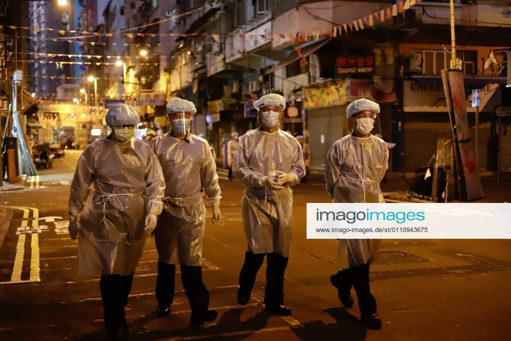 Government staffs dressed in full protective gear walk through Temple Street in the early morning. Hong Kong Government have lifted partial lockdown in the designated zone after imposing 48 hours of restriction on local citizens.Jan-25,2021Hong Kong.ZUMA Hong Kong CHINA - ZUMAl137 20210125_zap_l137_010