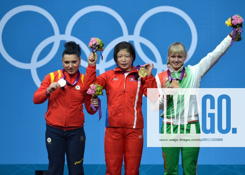 LONDON, Aug. 1, 2012 -- goldmedalist Rim Jong Sim of the Democratic People s Republic of Korea (C), silve medalist Roxana Daniela Cocos of Romania (L), and Bronzemedalist Maryna Shkermankova of Belarus celebrate at the awarding ceremony of women s 69kg weightlifting event at London 2012 Olympic Games, London, Britain, Aug. 1, 2012. (Xinhua Gong Lei) (OLY2012)BRITAIN-LONDON-WEIGHTLIFTING-WOMEN-69KG