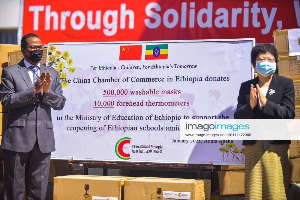 (210127) -- ADDIS ABABA, Jan. 27, 2021 -- Liu Yu (R), minister counselor for Economic and Commercial Affairs of the Chinese Embassy to Ethiopia, and Getahun Mekuria, Ethiopia Minister of Education, attend a donation ceremony in Addis Ababa, Ethiopia on Jan. 26, 2021. The China Chamber of Commerce in Ethiopia (CCCE) on Tuesday donated 500,000 washable masks and 10,000 thermometers to the Ethiopia Ministry of Education (MoE). ) ETHIOPIA-CHINA-DONATION CEREMONY-MEDICAL SUPPLIES MichaelxTewelde