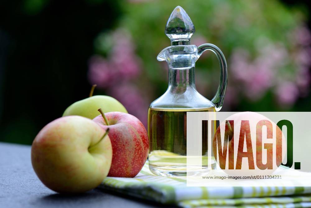 Carafe with apple cider vinegar and apples