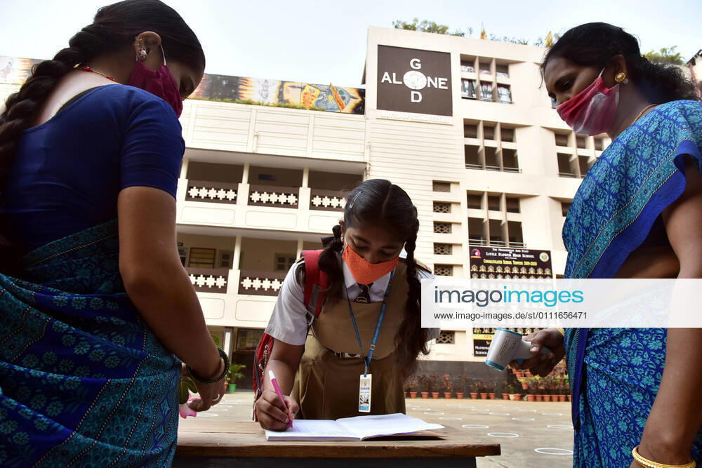 (210201) -- HYDERABAD, Feb. 1, 2021 -- A student signs on a book before entering a school after a gap of almost a year following COVID-19 guidelines in Hyderabad, capital of India s southern state of Telengana on Feb. 1, 2021. (Str Xinhua) INDIA-HYDERABAD-SCHOOL REOPENS ParthaxSarkar