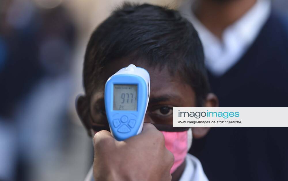 A student undergoes thermal screening before entering Model Senior Secondary School Urban Estate at Sector 4, on February 1, 2021 in Gurugram, India. Schools in Gurugram reopened for 6th to 8th standard today. (Photo by Vipin Kumar Hindustan Times) Daily Life Amid Covid-19 Pandemic In India