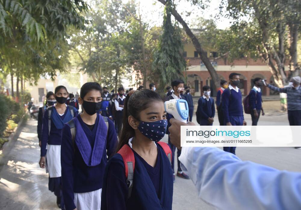 A student undergoes thermal screening before entering Model Senior Secondary School Urban Estate at Sector 4, on February 1, 2021 in Gurugram, India. Schools in Gurugram reopened for 6th to 8th standard today. (Photo by Vipin Kumar Hindustan Times) Daily Life Amid Covid-19 Pandemic In India