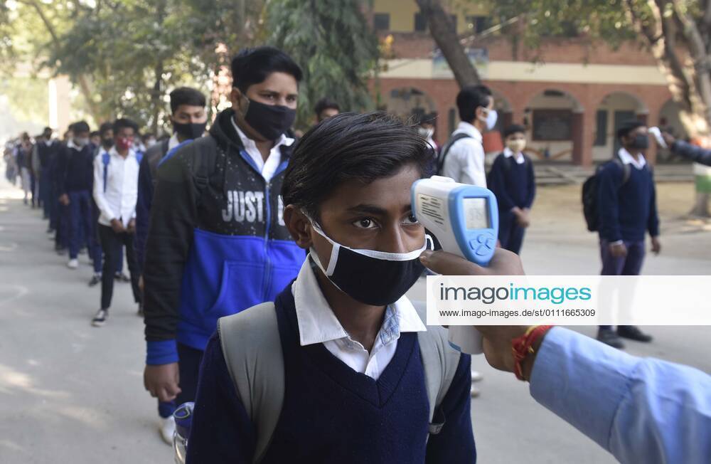 A student undergoes thermal screening before entering Model Senior Secondary School Urban Estate at Sector 4, on February 1, 2021 in Gurugram, India. Schools in Gurugram reopened for 6th to 8th standard today. (Photo by Vipin Kumar Hindustan Times) Daily Life Amid Covid-19 Pandemic In India
