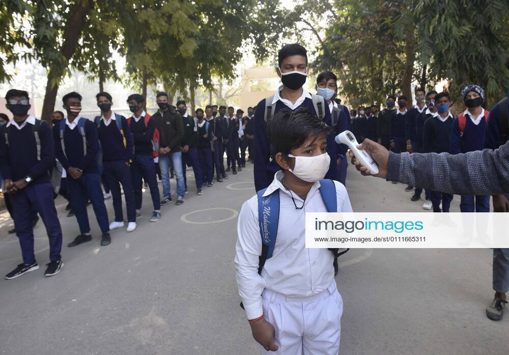 A student undergoes thermal screening before entering Model Senior Secondary School Urban Estate at Sector 4, on February 1, 2021 in Gurugram, India. Schools in Gurugram reopened for 6th to 8th standard today. (Photo by Vipin Kumar Hindustan Times) Daily Life Amid Covid-19 Pandemic In India