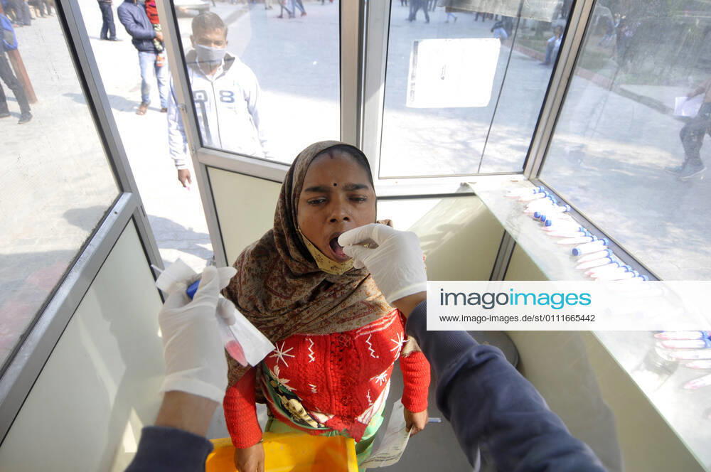 A health worker collects a swab sample from a woman for Covid-19 test, at Sector 30 District Hospital, on February 1, 2021 in Noida, India. (Photo by Sunil Ghosh Hindustan Times) Daily Life Amid Covid-19 Pandemic In India