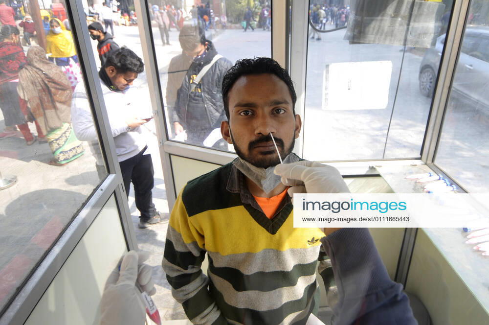 A health worker collects a swab sample from a man for Covid-19 test, at Sector 30 District Hospital, on February 1, 2021 in Noida, India. (Photo by Sunil Ghosh Hindustan Times) Daily Life Amid Covid-19 Pandemic In India