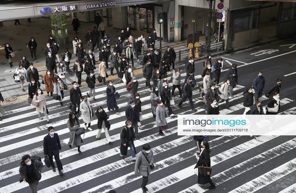 Japan to extend virus emergency to March 7 as hospitals strained People wearing face masks walk in front of JR Osaka Station on Feb. 2, 2021. The Japanese government is set to extend a coronavirus state of emergency for Tokyo, Osaka and other regions by one month to March 7 in view of manpower-strapped hospitals amid a surge in serious patients.