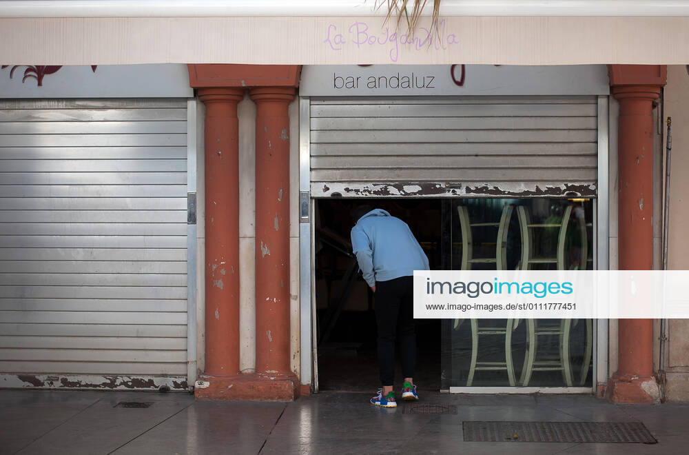 A person entering into the partially closed La Bougadilla restaurant during the closure of the hospitality sector and non-essential activities as part of a partial lockdown..For two weeks, besides the limit on mobility between cities, many municipalities and Costa del Sol districts (including the Malaga capital) will have to close bars, restaurants and stores as measures to curb the spread of the coronavirus pandemic. In the lead of Andalusia, Malaga is the city with more daily coronavirus infections and a high rate of hospitalizations. Malaga Spain - ZUMAs197 20210202_zab_s197_008