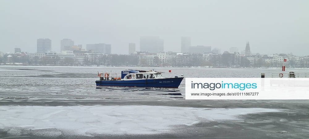 Hamburg in Corona Lockdown scenes in February 2021 around the Hamburg Außenalster scenes from the lockdown at the Alster in Hamburg police boat WS police 19 on the Alster with ice police boat ship Hamburg in Corona Lockdown scenes in February 2021 around the Hamburg Außenalster , Hamburg Hamburg Germany downtown around the Alster