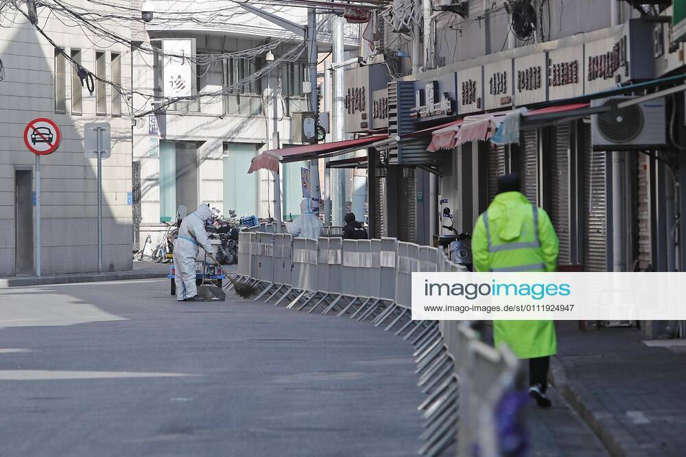 A worker wearing personal protective equipment (PPE) cleans up a road at a residential community under lockdown at Huangpu District on February 4, 2021 in Shanghai, China.