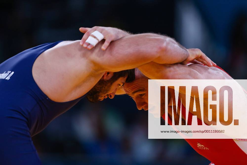 (120811) -- LONDON, Aug. 11, 2012 (Xinhua) -- Artur Taymazov of Uzbekistan (red) competes with Davit Modzmanashvili of Georgia during the Men s 120kg Freestyle gold medal match of Wrestling at London 2012 Olympic Games, London, Britain, Aug. 11, 2012. Artur Taymazov of Uzbekistan won the match and claimed the gold medal of the event. (Xinhua Jin Liwang) (OLY2012)BRITAIN-LONDON-WRESTLING-MEN-60KG