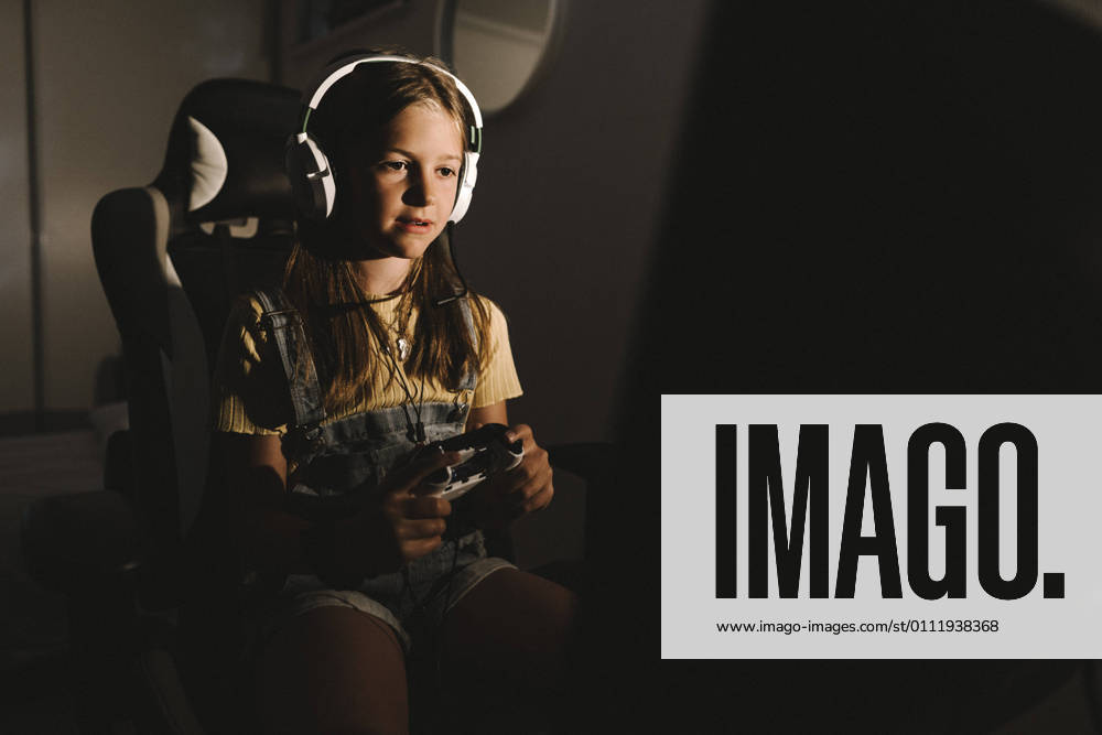 Girl playing video game at home during night Sweden, Gothenburg, model released, property released