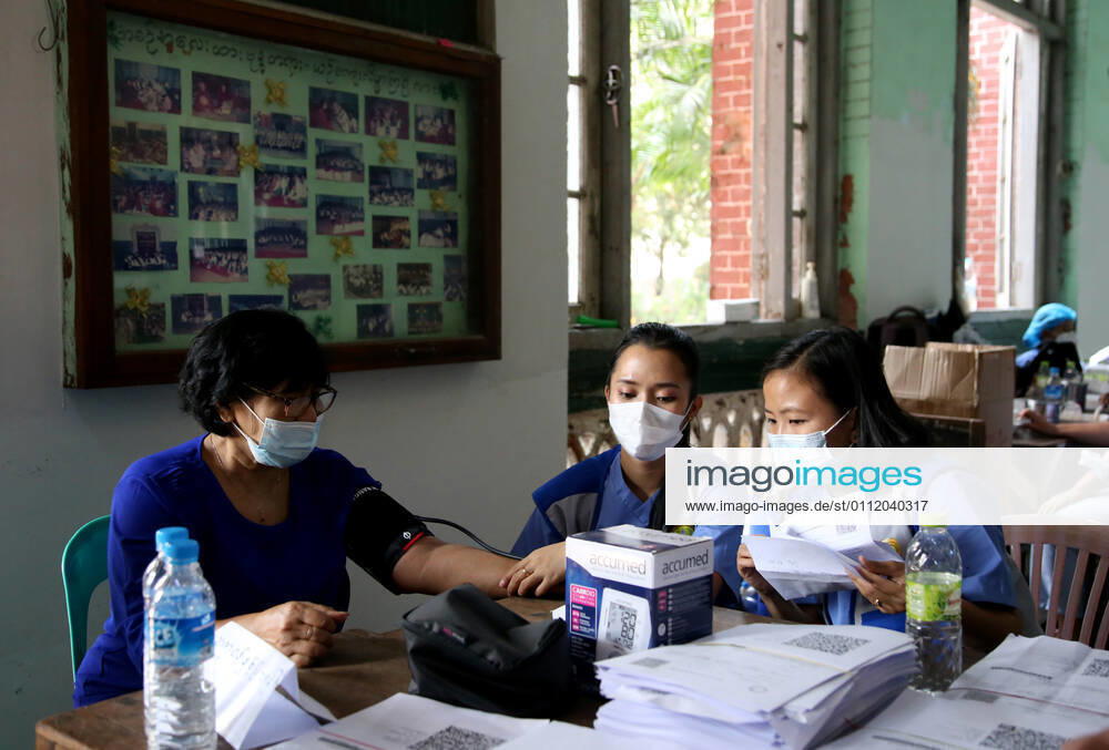 (210205) -- YANGON, Feb. 5, 2021 -- Medical workers check the physical condition of a woman before she receives the COVID-19 vaccine at a school in Yangon, Myanmar, Feb. 5, 2021. Myanmar resumed the vaccination program against COVID-19 across the country on Friday, according to an announcement from the Health and Sports Ministry. (Photo by Xinhua) MYANMAR-VACCINATION-COVID-19-RESUMPTION Haymhan