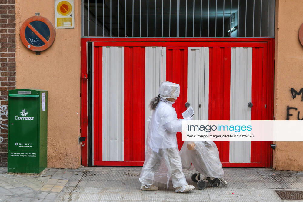 February 5, 2021 (Malaga) Woman dressed from the feet to the head of plastic and protections for fear of the Coronavirus or Covid 19 ,goes out to the protected street. - ZUMAc161 20210205_zap_c161_027