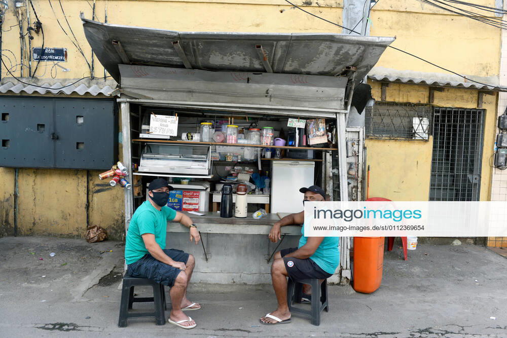 Brazil under COVID-19 RIO DE JANEIRO, BRAZIL, APR 30: COVID 19 - people wearing a mask in a small shop at Cidade de Deus favela on April 30, 2020. ( Photo by Chico Ferreira Penta Press ) Rio de Janeiro Brazil 5952_228659