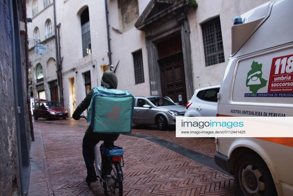 Perugia in the red zone. The capital and the province in full state of emergency covid 19 also due to the variants of the virus present in the area. the city is back in full lockdown. the deserted historic center. anguish and fear reign. an ambulance with lights and sirens on in via Oberdan. an amulance with the lights on in via oberdan. Editorial Usage Only