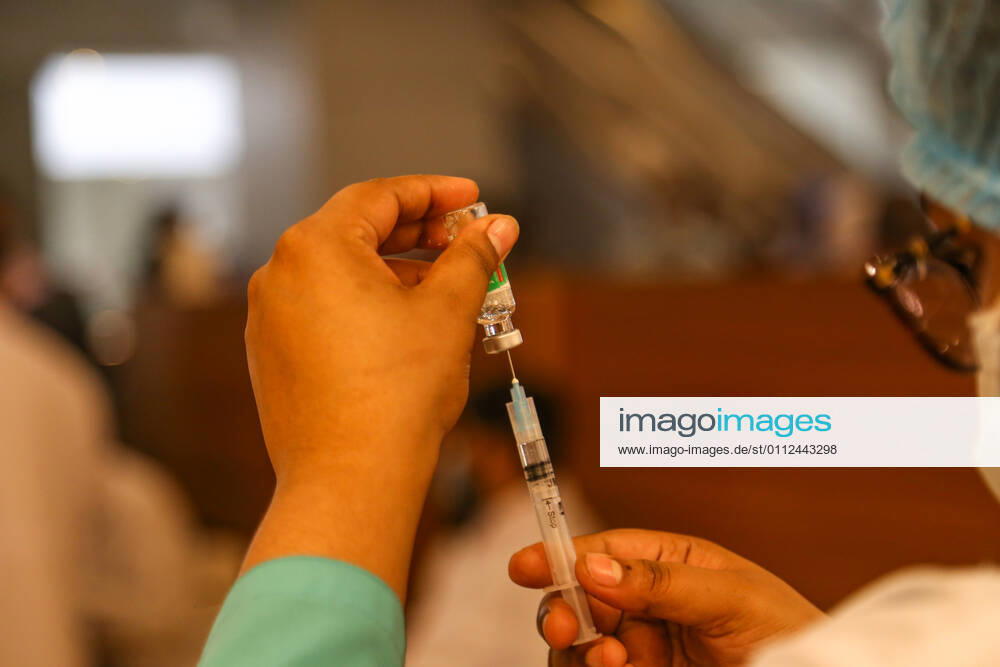 Bangladesh: Covid-19 vaccination drive begins in Dhaka A medical worker preparing a syringe and an ampule with the dose of Covishield covid-19 vaccine during the vaccination drive. Dhaka Dhaka Division Bangladesh