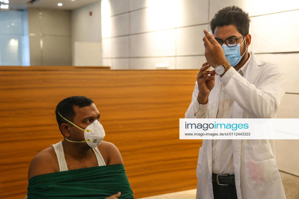 Bangladesh: Covid-19 vaccination drive begins in Dhaka A medical worker preparing a syringe and an ampule with the dose of Covishield covid-19 vaccine during the vaccination drive. Dhaka Dhaka Division Bangladesh